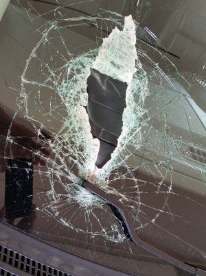 lawn mower blade embedded in windshield.jpg